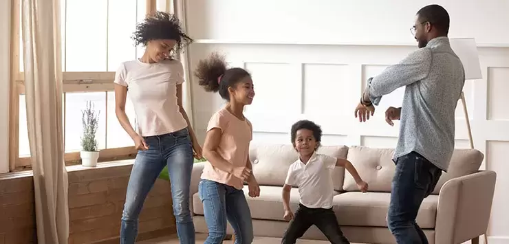 Family dancing in living rooom