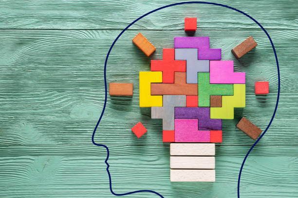 Brain outline with blocks forming a lightbulb inside the brain